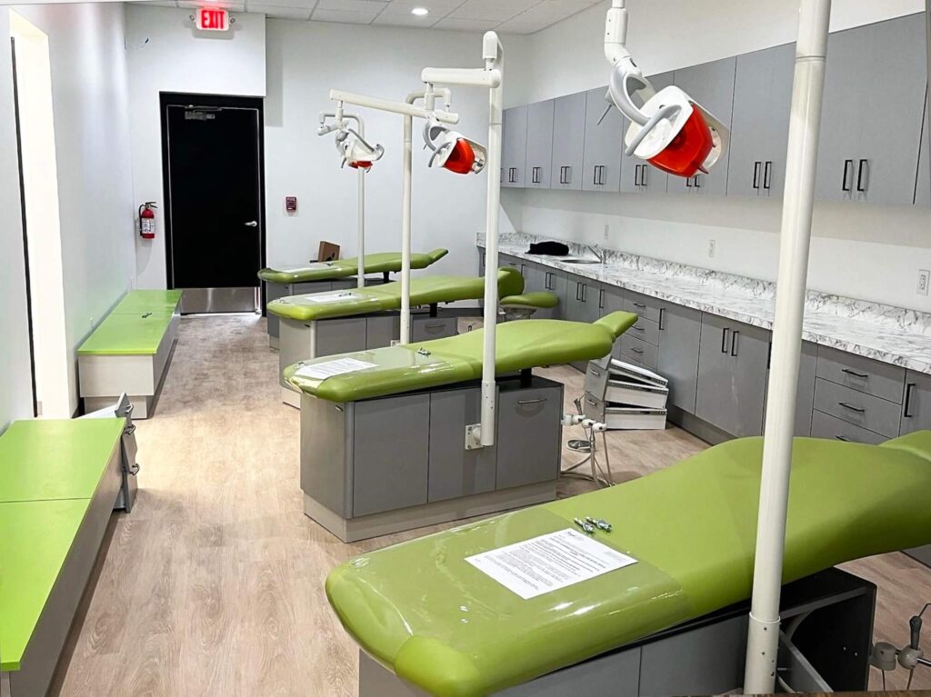 Spacious dental treatment room equipped with modern chairs and lighting at Justin Thompson Dental